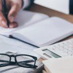 man working on a finance calculator