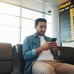 a man is waiting because of a delayed flight and is checking his Finhabits app