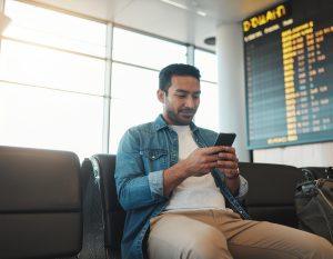 a man is waiting because of a delayed flight and is checking his Finhabits app